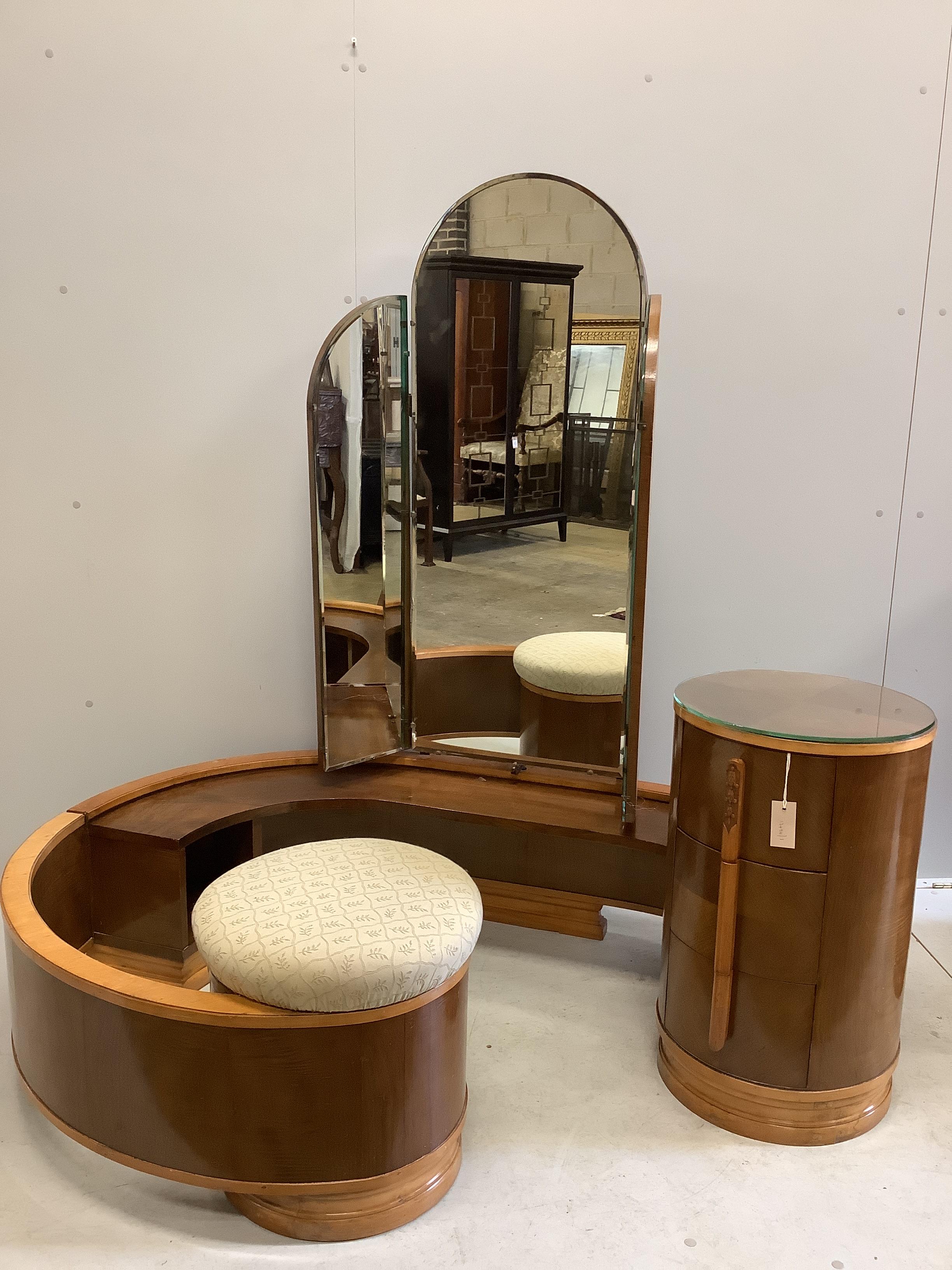 An Art Deco curved walnut dressing table, width 160cm, depth 106cm, height 156cm together with a matching headboard with integral bedside cabinet, width 238cm, height 126cm